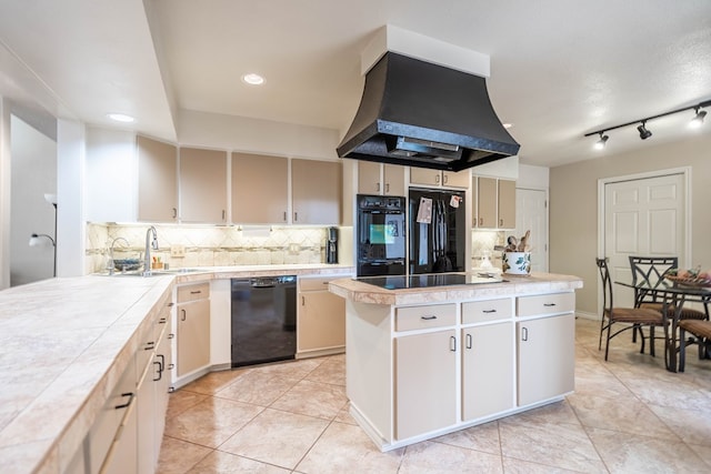 1115 Gulf Ave, Midland, TX 79705 - kitchen with black appliances, exhaust hood, a sink, a center island, and tasteful backsplash