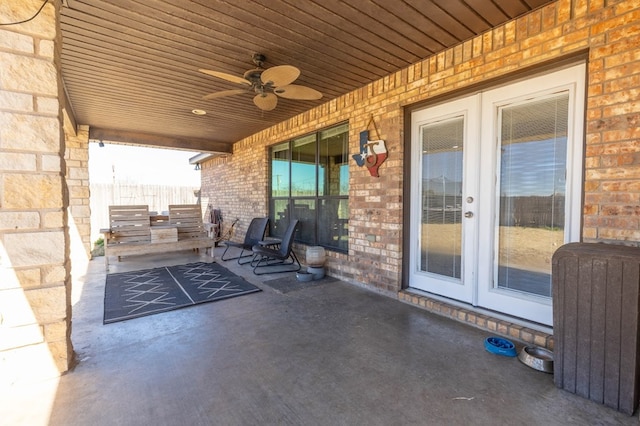 view of patio featuring french doors, ceiling fan, and radiator