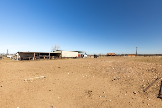 view of yard with an outbuilding and a rural view