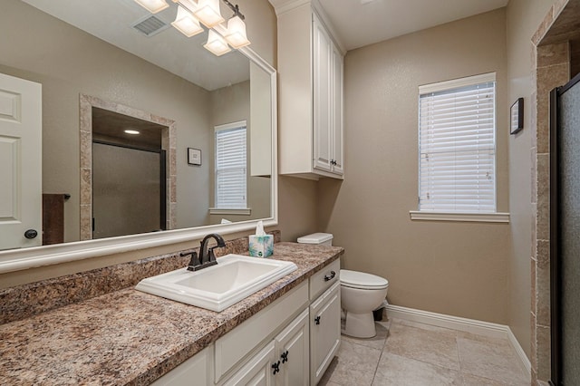 bathroom featuring a stall shower, visible vents, vanity, and baseboards