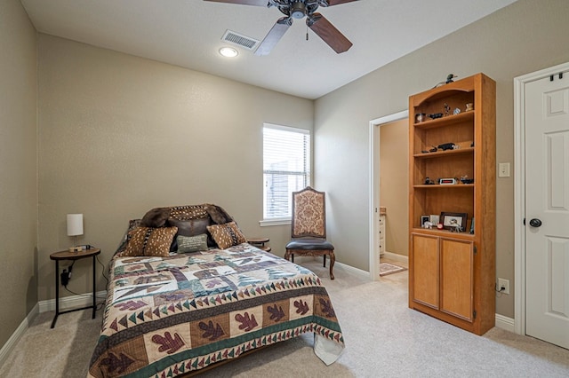 bedroom with a ceiling fan, light colored carpet, visible vents, and baseboards