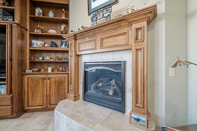 room details featuring a tile fireplace and built in features