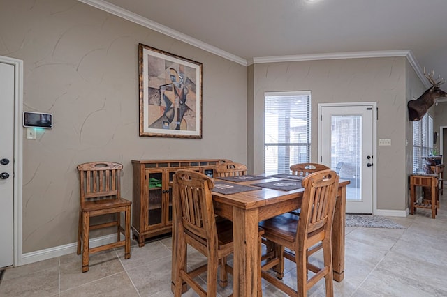 dining room with ornamental molding and baseboards