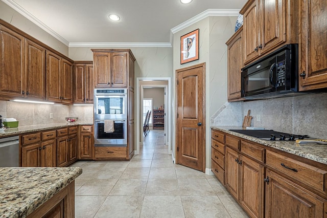 kitchen with black appliances, light stone counters, decorative backsplash, and crown molding