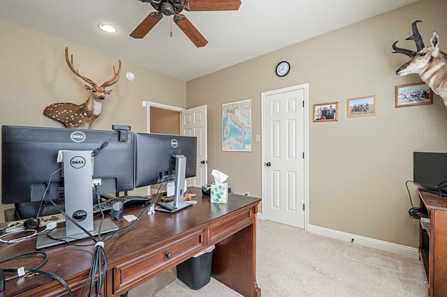 office with a ceiling fan, light carpet, and baseboards