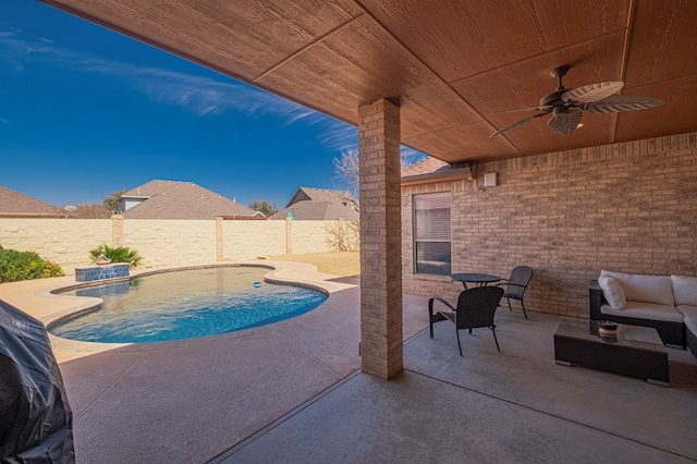 view of swimming pool with a ceiling fan, a fenced in pool, a patio area, and a fenced backyard