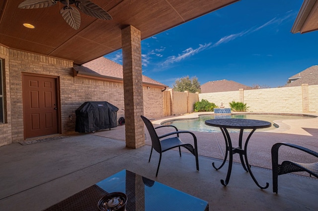 view of patio / terrace featuring area for grilling, a fenced backyard, and a ceiling fan