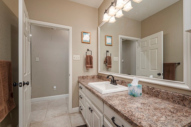 bathroom featuring tile patterned flooring, vanity, and baseboards