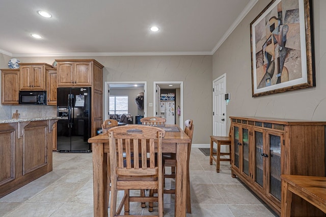 dining area featuring baseboards, recessed lighting, and crown molding