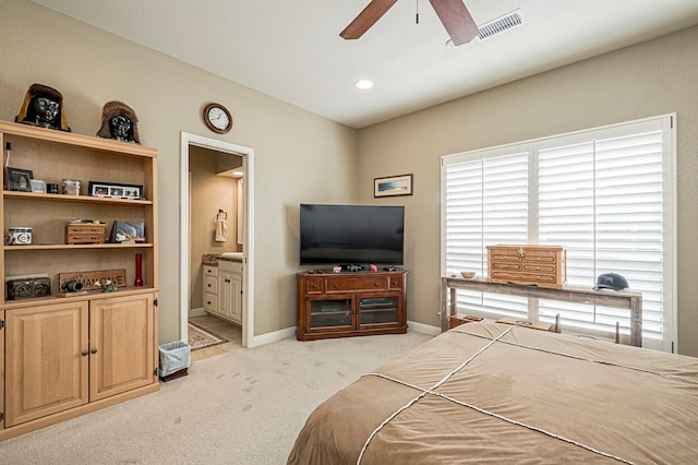 bedroom featuring visible vents, light carpet, connected bathroom, ceiling fan, and baseboards