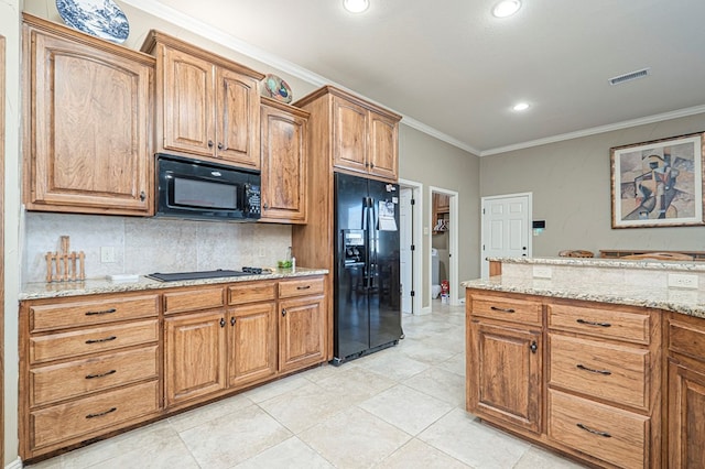 kitchen featuring light stone counters, visible vents, backsplash, black appliances, and crown molding