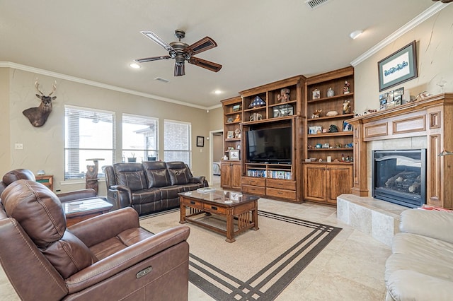 living area featuring visible vents, ornamental molding, a tile fireplace, and a ceiling fan