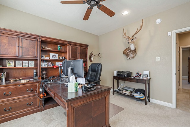 office with ceiling fan, vaulted ceiling, baseboards, and light colored carpet