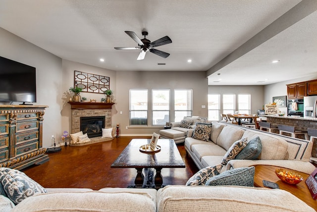 living room with recessed lighting, a glass covered fireplace, a ceiling fan, and baseboards