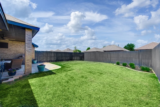 view of yard with a patio area and a fenced backyard