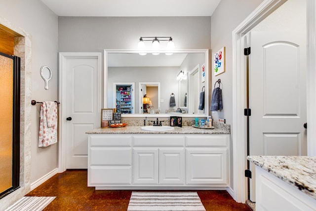 full bathroom featuring baseboards, a shower stall, vanity, and finished concrete floors