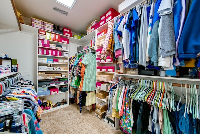spacious closet featuring visible vents and carpet