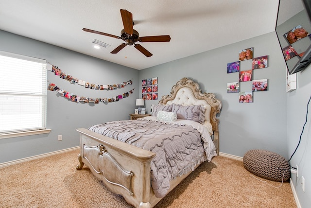 bedroom with baseboards, visible vents, carpet, and ceiling fan