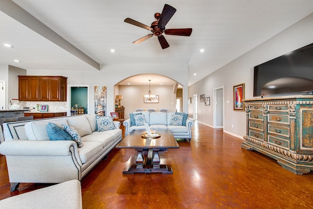living room with recessed lighting, arched walkways, and ceiling fan with notable chandelier