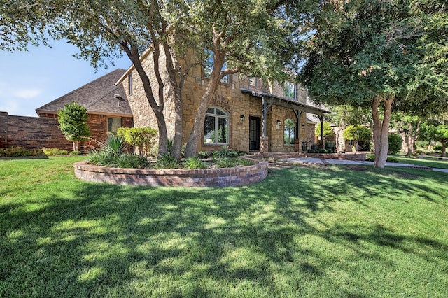 1102 Silverton Dr, Midland, TX 79705 - view of front of property with a front lawn, stone siding, and a shingled roof