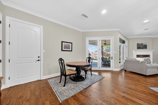 1102 Silverton Dr, Midland, TX 79705 - dining area with wood finished floors, crown molding, recessed lighting, and a fireplace