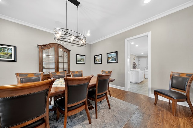 1102 Silverton Dr, Midland, TX 79705 - dining space with wood finished floors, recessed lighting, crown molding, and a chandelier
