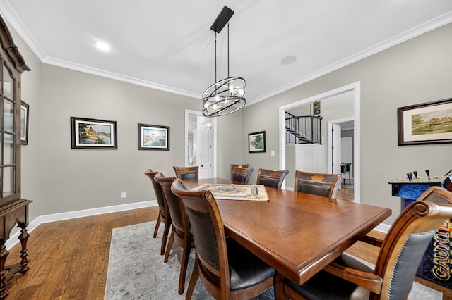 1102 Silverton Dr, Midland, TX 79705 - dining room featuring wood finished floors, crown molding, and a chandelier