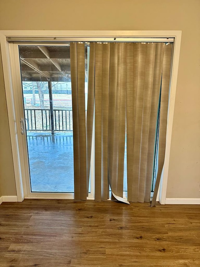 entryway with wood-type flooring