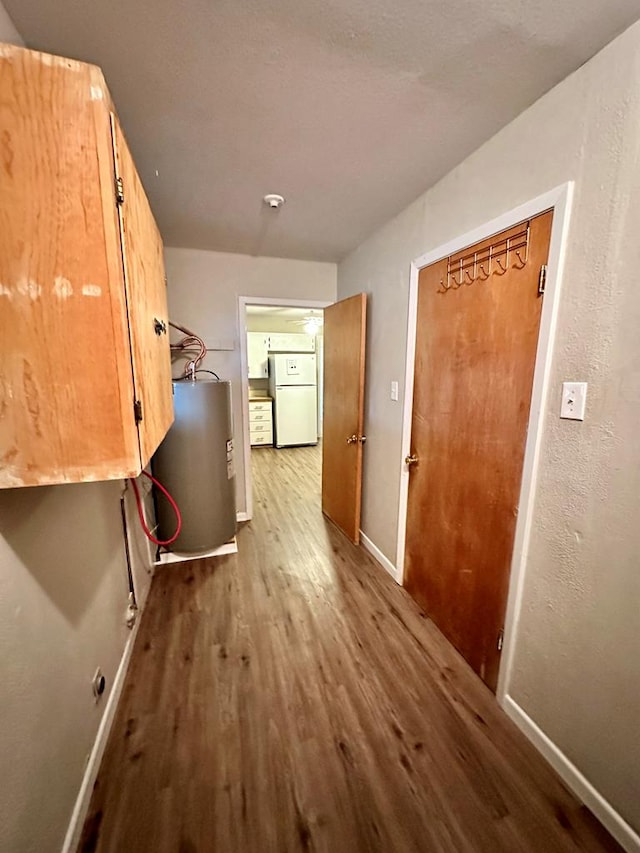 interior space with hardwood / wood-style flooring and water heater