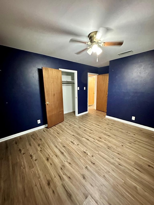 unfurnished bedroom with light hardwood / wood-style floors and ceiling fan