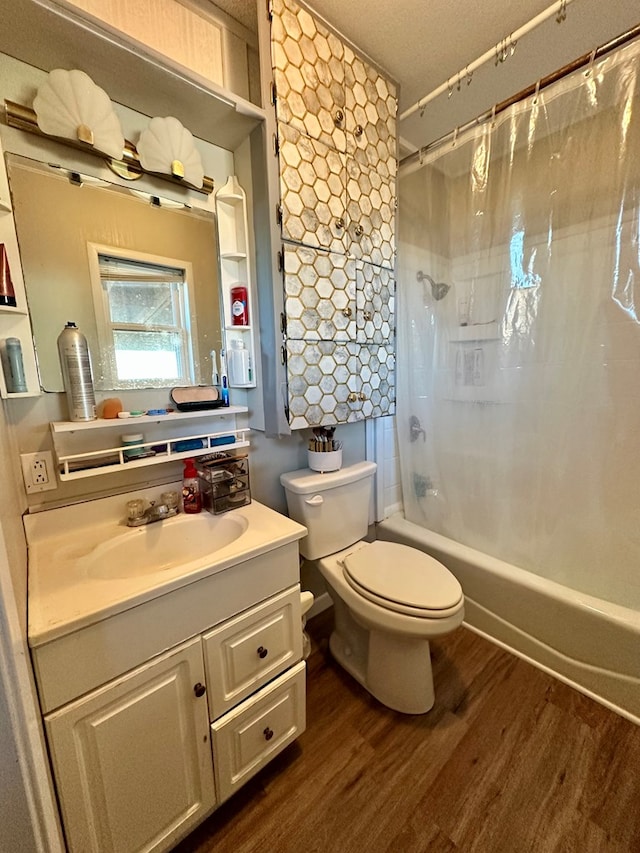 full bathroom featuring toilet, a textured ceiling, vanity, shower / bath combo with shower curtain, and hardwood / wood-style flooring