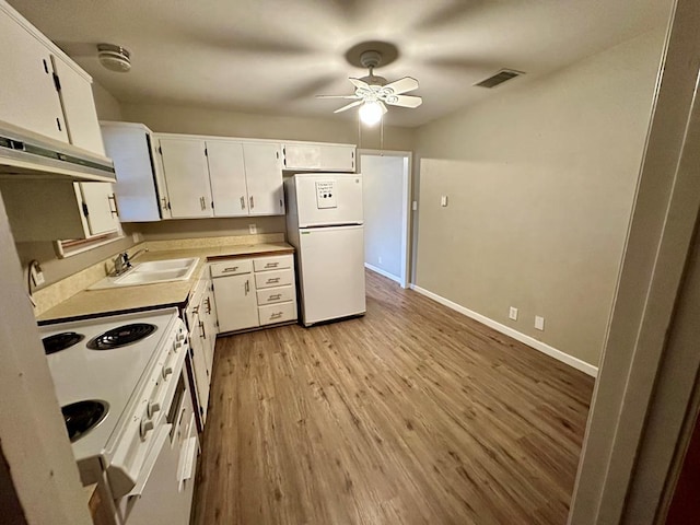 kitchen with white cabinetry, sink, ceiling fan, white appliances, and light hardwood / wood-style flooring