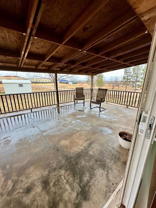 view of patio featuring a storage unit