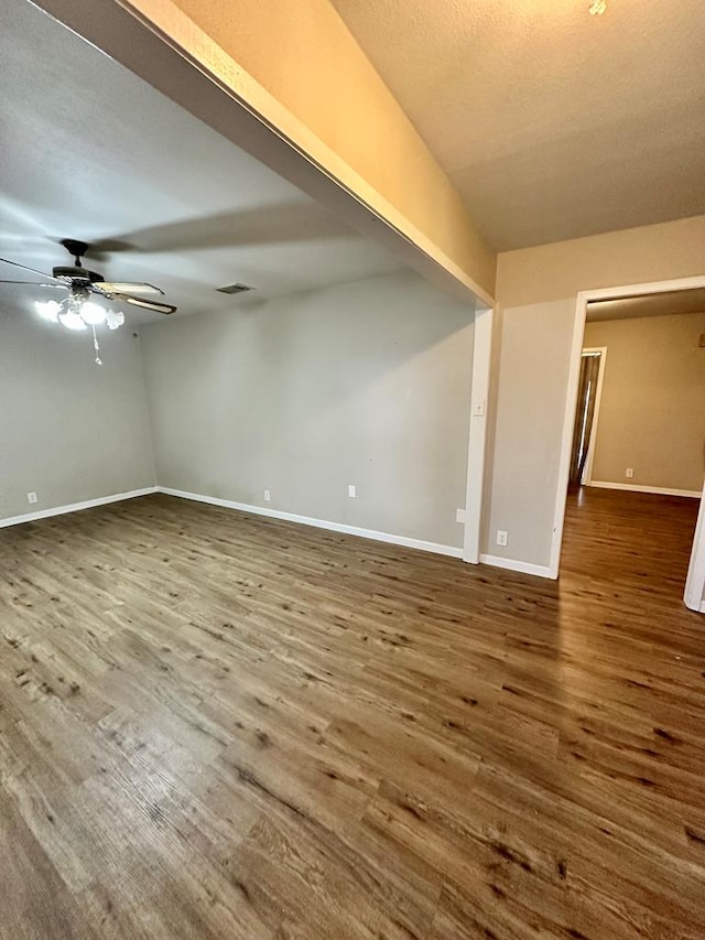 empty room featuring hardwood / wood-style flooring and ceiling fan