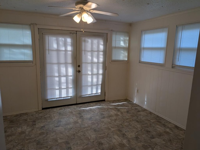 doorway with a ceiling fan, a textured ceiling, crown molding, and french doors