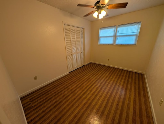 unfurnished bedroom featuring baseboards, a closet, carpet floors, and a ceiling fan