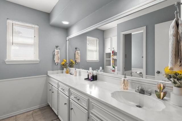 2821 Goddard Pl, Midland, TX 79705 - full bathroom featuring double vanity, baseboards, and tile patterned flooring