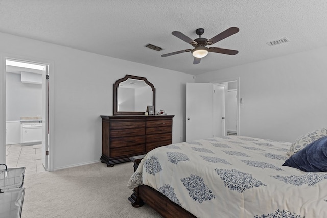 2821 Goddard Pl, Midland, TX 79705 - bedroom with a textured ceiling, light carpet, ceiling fan, connected bathroom, and baseboards