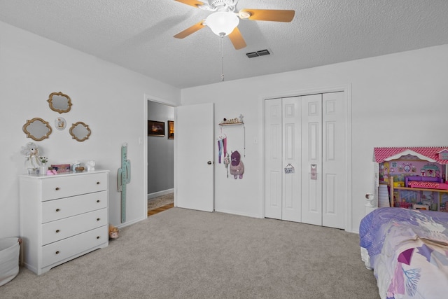 2821 Goddard Pl, Midland, TX 79705 - carpeted bedroom with a closet, a textured ceiling, and ceiling fan