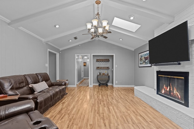 2821 Goddard Pl, Midland, TX 79705 - living area with light wood-style flooring, a skylight, a fireplace, a chandelier, and baseboards