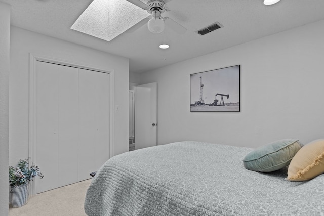 2821 Goddard Pl, Midland, TX 79705 - bedroom with carpet, a skylight, a closet, and a ceiling fan