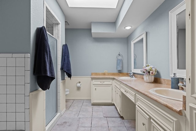 2821 Goddard Pl, Midland, TX 79705 - full bathroom featuring double vanity, tile patterned flooring, toilet, and an enclosed shower