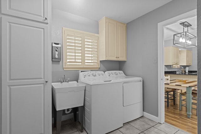 2821 Goddard Pl, Midland, TX 79705 - washroom with separate washer and dryer, cabinet space, and light tile patterned floors