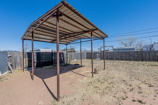 view of yard featuring a carport, driveway, and fence