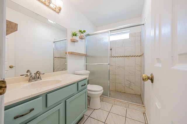 full bathroom with vanity, a shower stall, and toilet