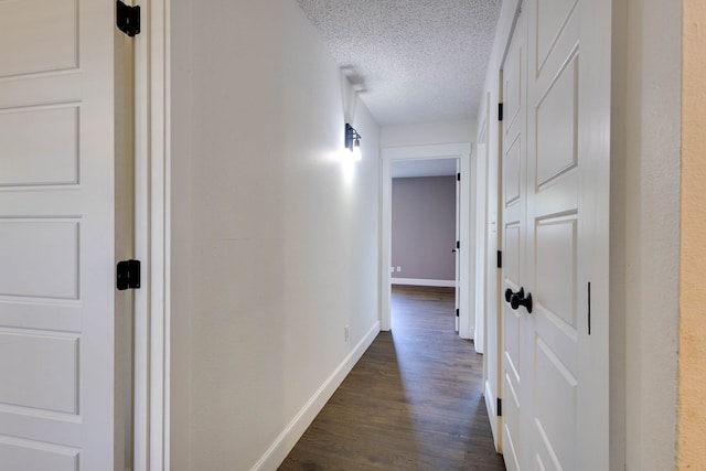 709 21st St, Lamesa, TX 79331 - corridor featuring dark wood-style flooring and a textured ceiling