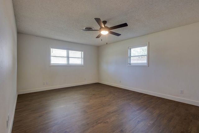709 21st St, Lamesa, TX 79331 - unfurnished room with plenty of natural light, dark wood finished floors, a ceiling fan, and a textured ceiling