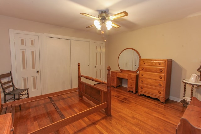 bedroom featuring ceiling fan, wood-type flooring, and a closet