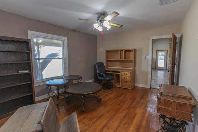 home office featuring ceiling fan and dark hardwood / wood-style floors