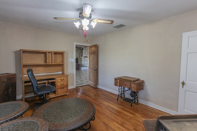 office space with ceiling fan and dark hardwood / wood-style flooring